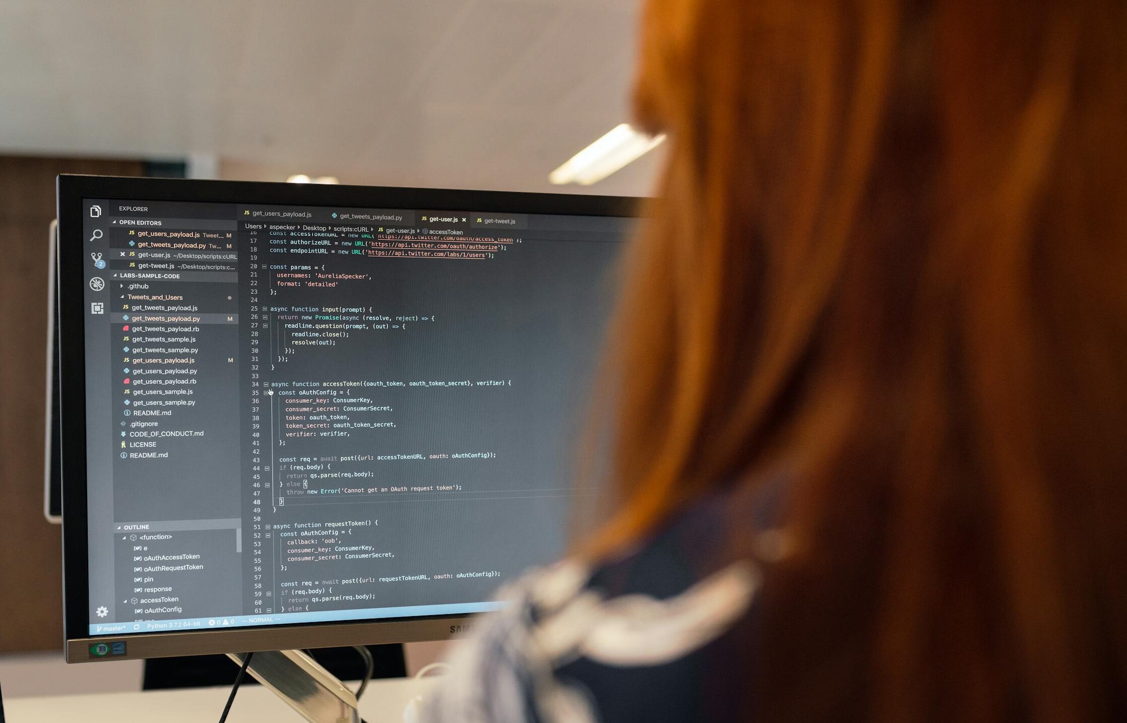 A female engineer works on code in a contemporary office setting, showcasing software development.